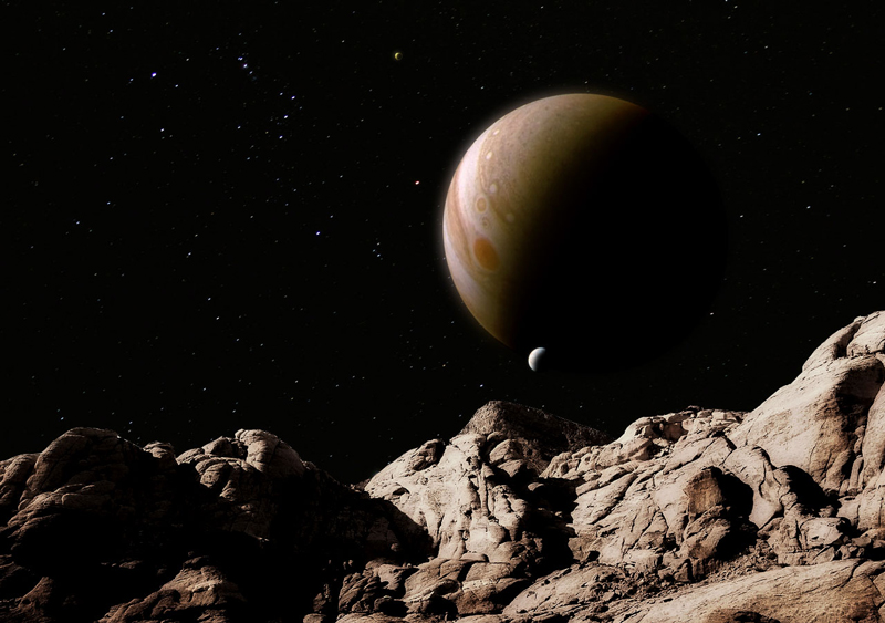 Jupiter rising over an alien landscape; a JunoCam image grafted on background stars and Red Rock Canyon.