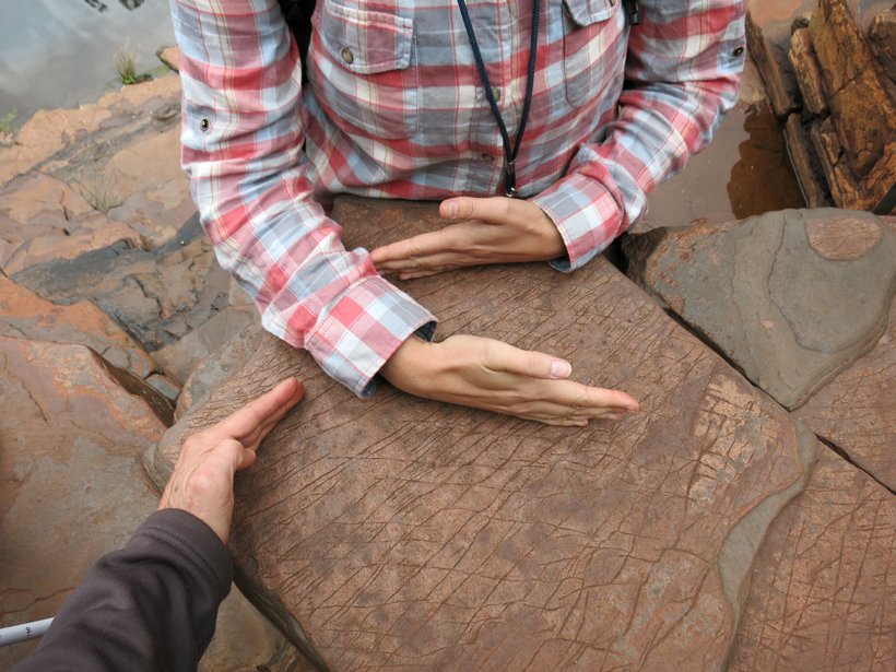 Hand gestures are one means of illustrating geological concepts, like the orientation of these rock fractures.