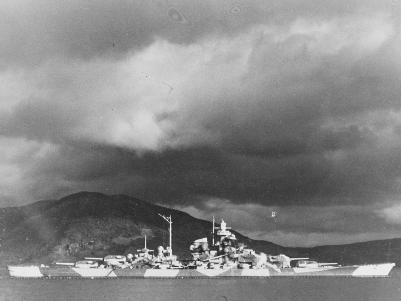 German warship Tirpitz at anchor in Alta Fjord, protected by antitorpedo nets, in northern Norway during 1943–1944.