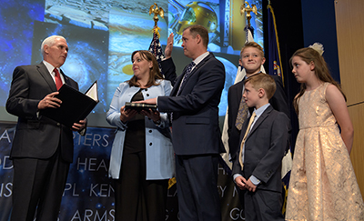 Jim Bridenstine, flanked by his wife and children, is sworn in as the new NASA administrator by Vice President Mike Pence.