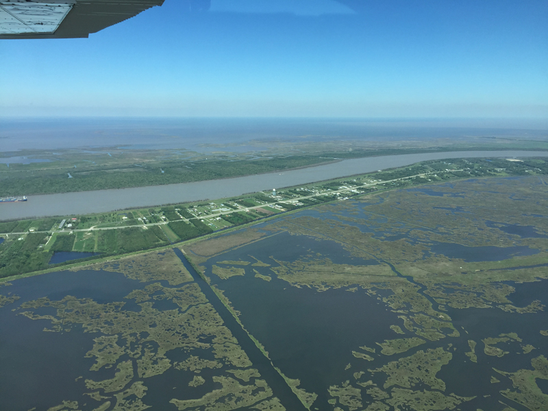 The Mississippi River, flanked by levees and surrounded by wetlands that are restricted from interacting with it.