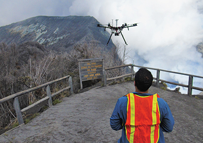 A drone pilot flies scientific instruments into the gas plume of Turrialba volcano
