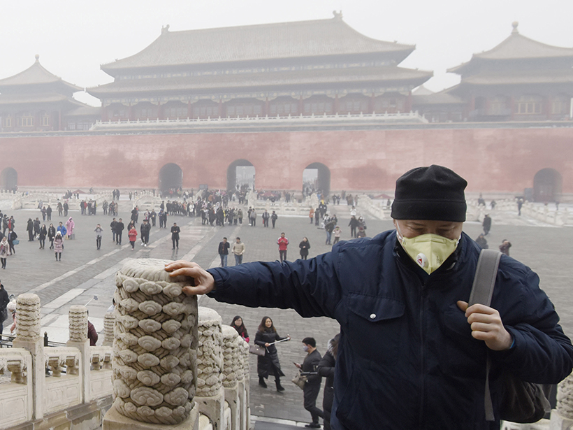 Person wearing air pollution mask in Beijing