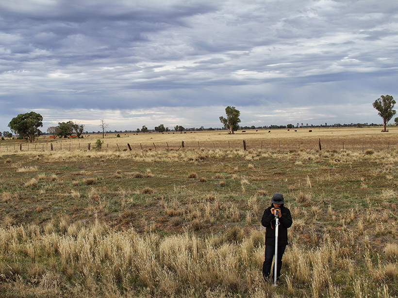 A researcher checking instruments used to collect soil moisture data