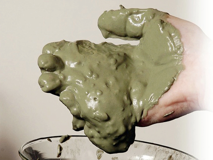 Clay chemist Lynda Williams holds a handful of green clay, which she shows has healing properties.