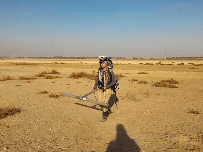 Rozan Alkhatib-Alkontar surveys a patch of ground at the site of the ancient city of Thaj, Saudi Arabia
