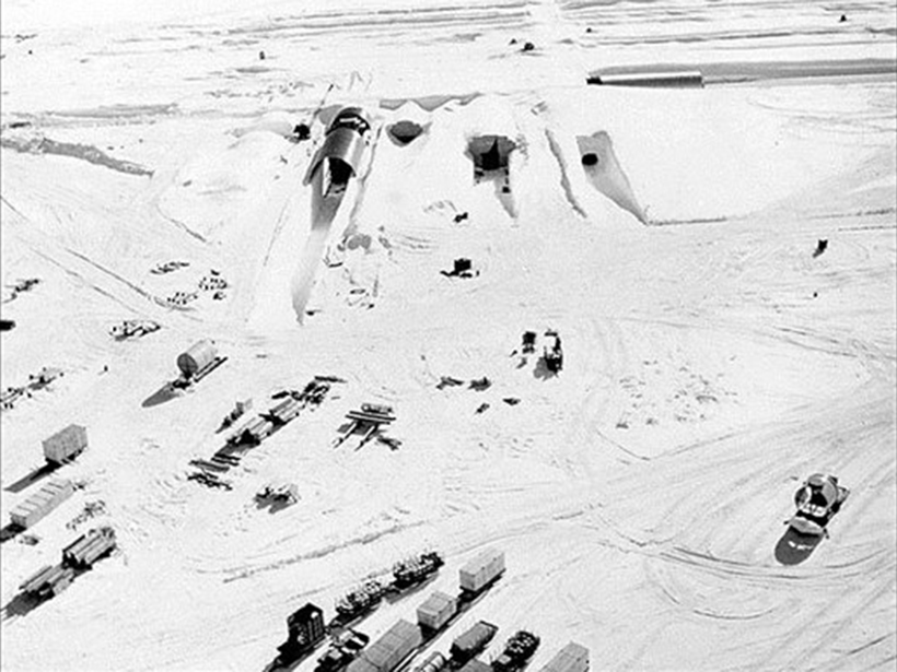 Trucks assemble outside an icy entrance to Camp Century in Greenland.