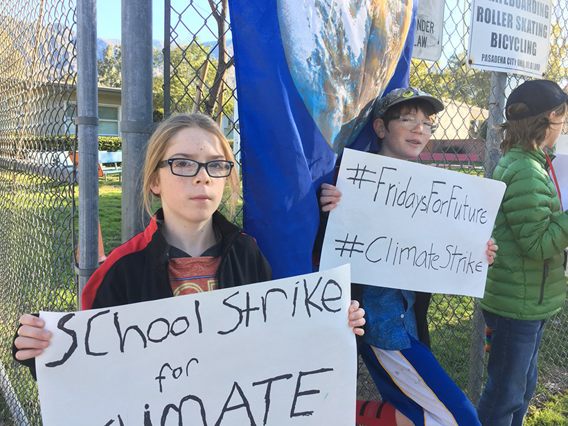 Students Zane and Braird hold a climate strike outside their school in California
