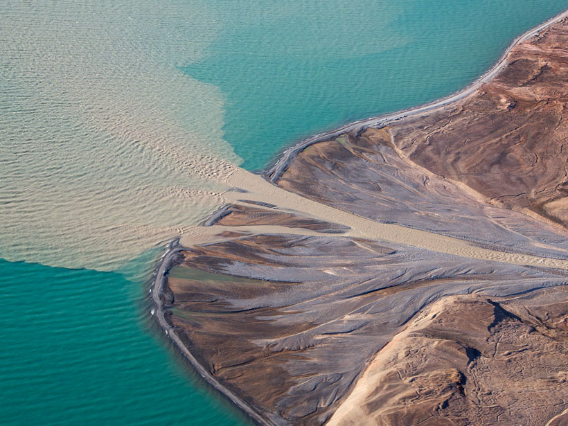 River water carrying sediment flows into the ocean.