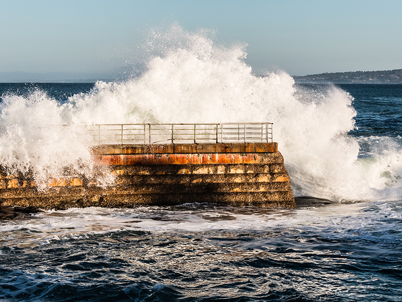 Pacific waves crash against a seawall in La Jolla, Calif.