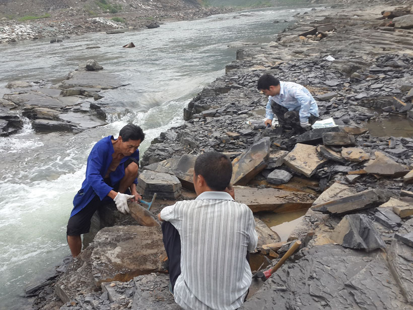 Researchers digging up a Qingjiang fossil on a bank of the Danshui River