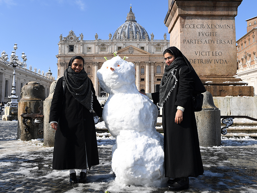 Nuns pose with a snowman at the Vatican in Rome on 26 February 2018.