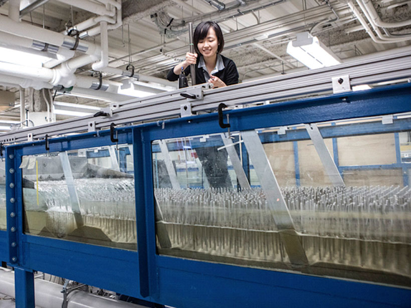 Judy Yang performing sediment movement experiments in a lab