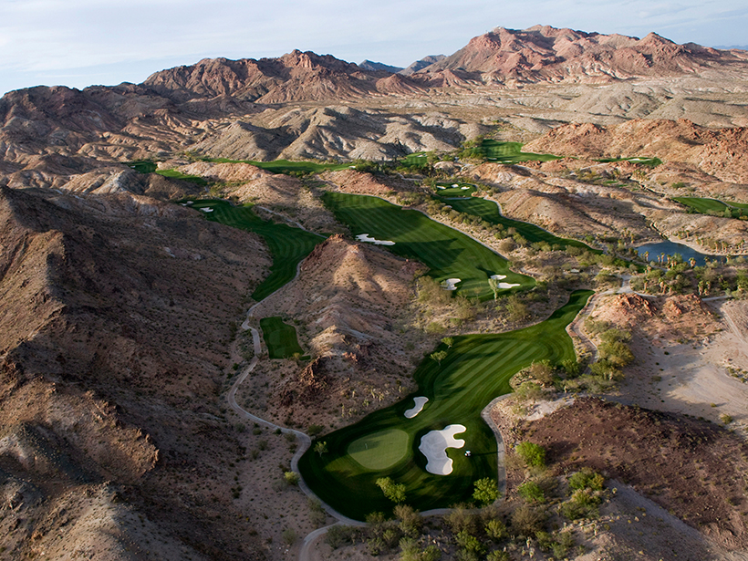 Aerial photo of a golf course in a hilly desert