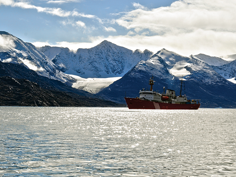Photo of a research vessel in front of a tidewater glacier