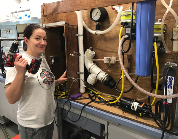 Oceanographer Ivona Cetinic holding a drill