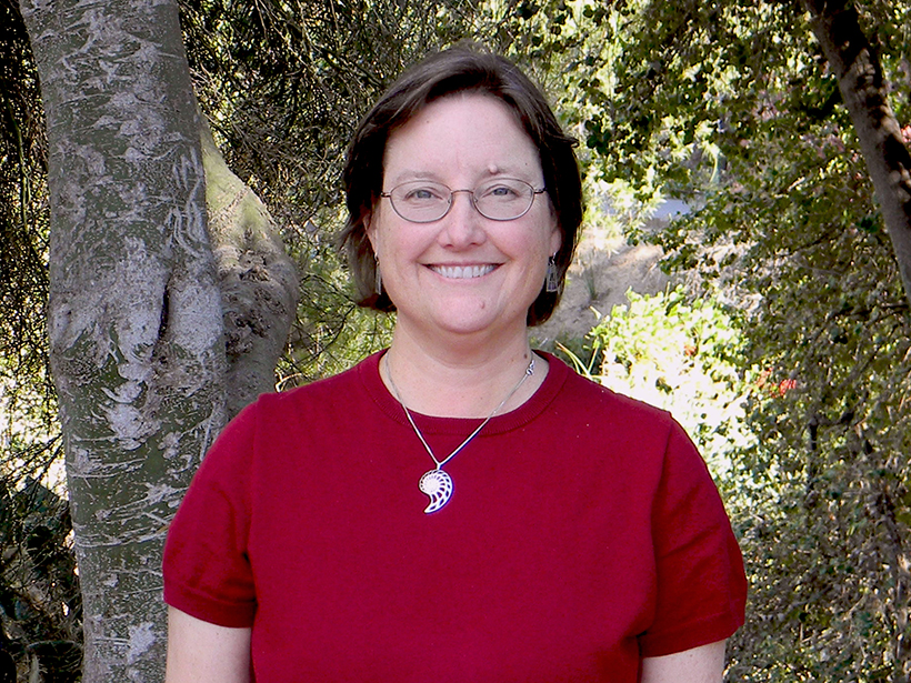 Portrait of a smiling white woman in the woods