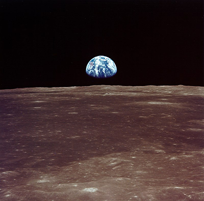 Earth rises over the horizon of the Moon.