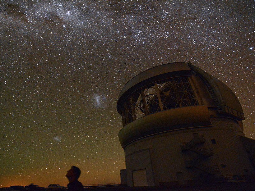 The Gemini South telescope at night, with the starry Milky Way in the background