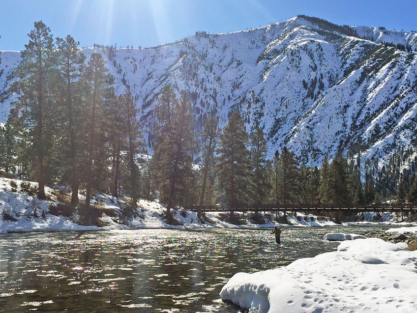 A river and snowy mountains on a sunny day