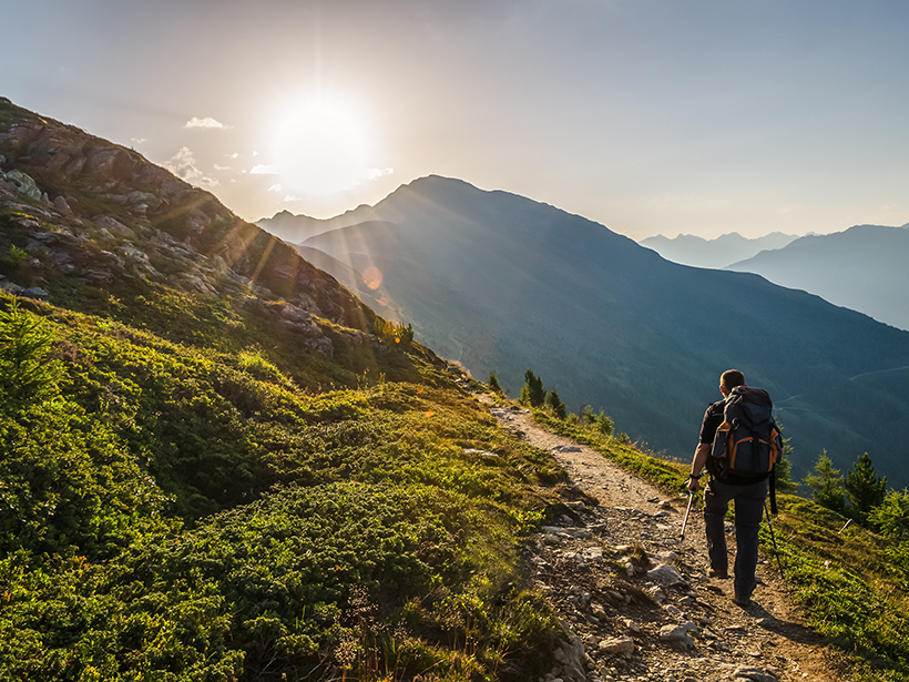 A hiker at sunrise in the Lechtaler Alps, Venetberg, Austria