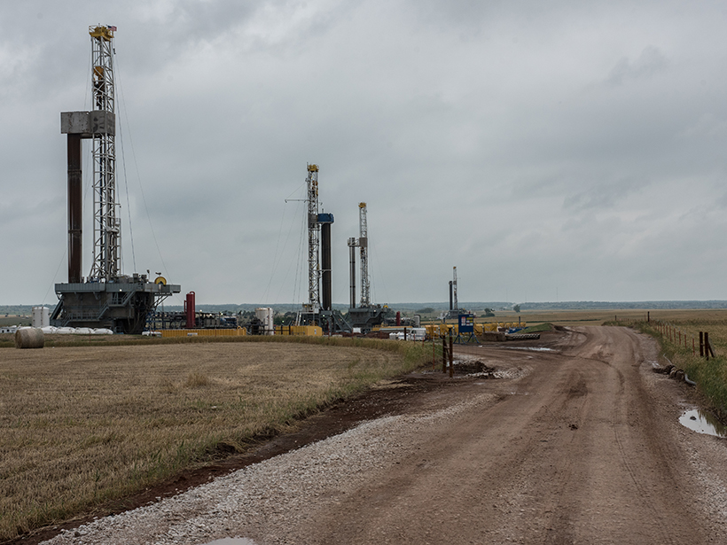 Photo of fracking rigs along a dirt road