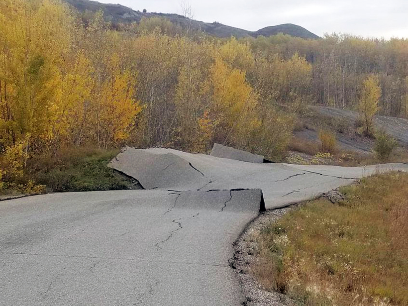 Buckled asphalt caused by a slow-moving landslide