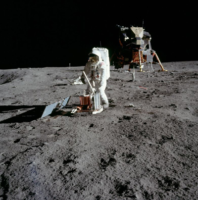 Astronaut placing instrument on the Moon