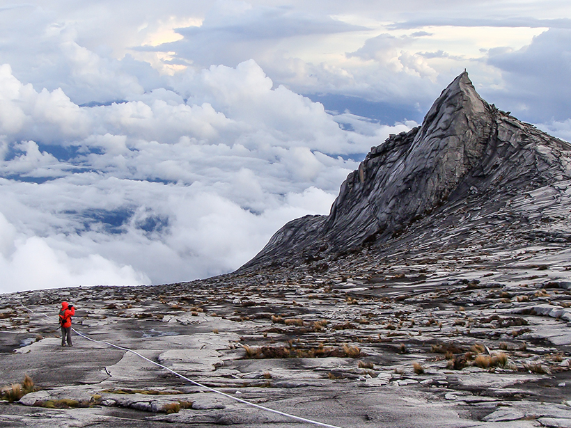 Person standing near Mount Kinabalu in Malaysia