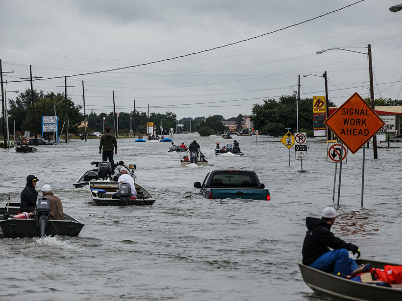 Rescuers motor down a badly flooded road in Port Arthur, Texas, on 30 August 2017 following heavy rainfall from Hurricane Harvey.
