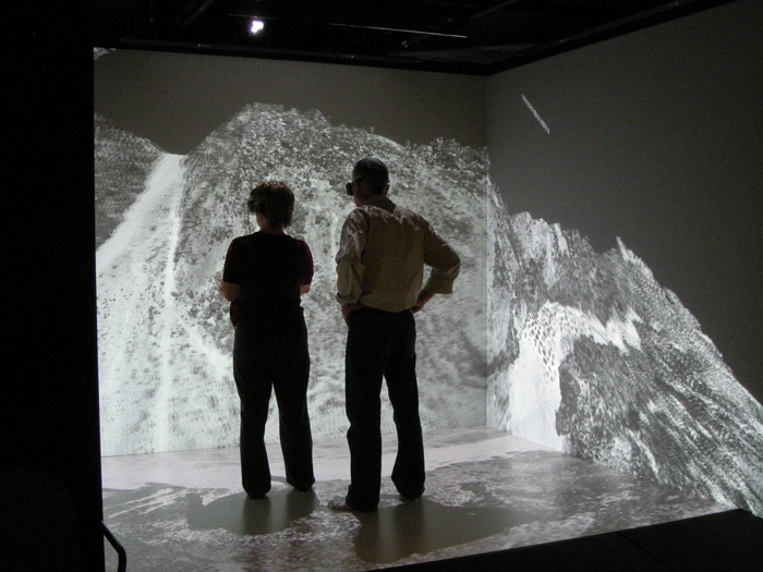 Two people in VR headsets stand in a small VR environment Two people in VR headsets stand in a small VR environment