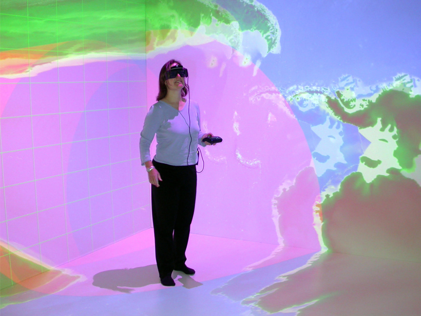 Louise Kellogg wears a VR headset in a VR environment