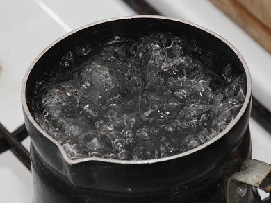 Pot of boiling water on a stove Pot of boiling water on a stove