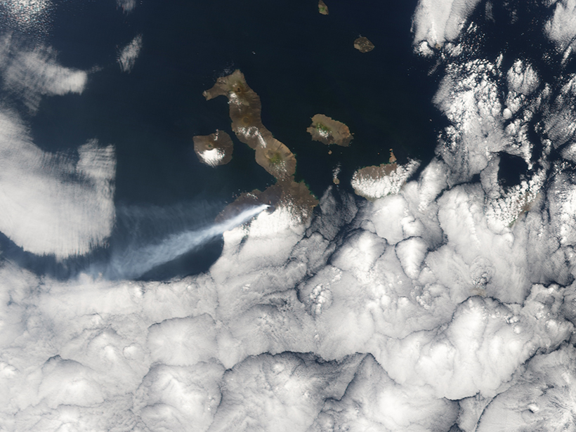 Ash from the Sierra Negra volcano on Isla Isabela in the Galápagos Islands drifts across the sky during an October 2005 eruption.
