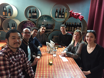 Design sprint participants sit together for dinner at a restaurant. Design sprint participants sit together for dinner at a restaurant.