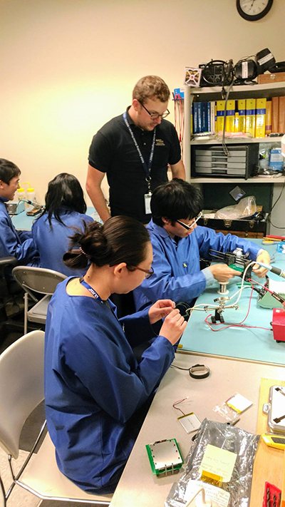 INSPIRE students learn by doing. Here, they learn to assemble solar panels. INSPIRE students learn by doing. Here, they learn to assemble solar panels.
