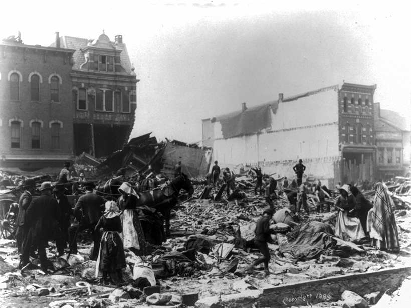 Black-and-white photo of people assessing damage from the 1889 Johnstown Flood