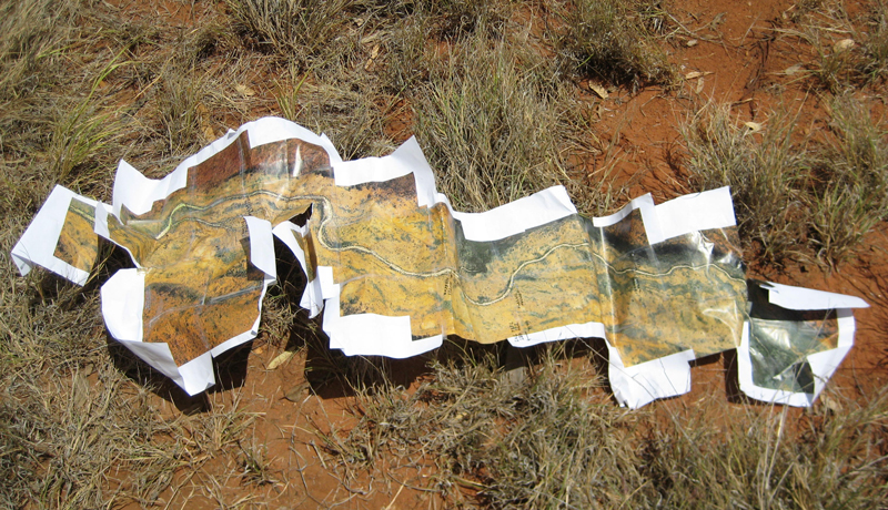 A map of a dry river sits on a patch of arid ground. A map of a dry river sits on a patch of arid ground.