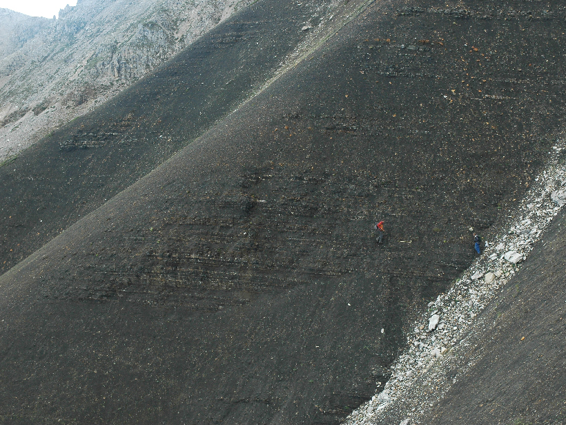 A mountainside exposing sedimentary rocks of the Fifteenmile Group in the Ogilvie Mountains, Yukon