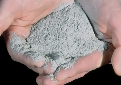 Two white hands holding volcanic ash Two white hands holding volcanic ash