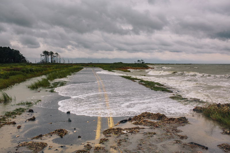 Water spills onto Hoopers Island Road, in Hoopersville, Md. during high tide.
