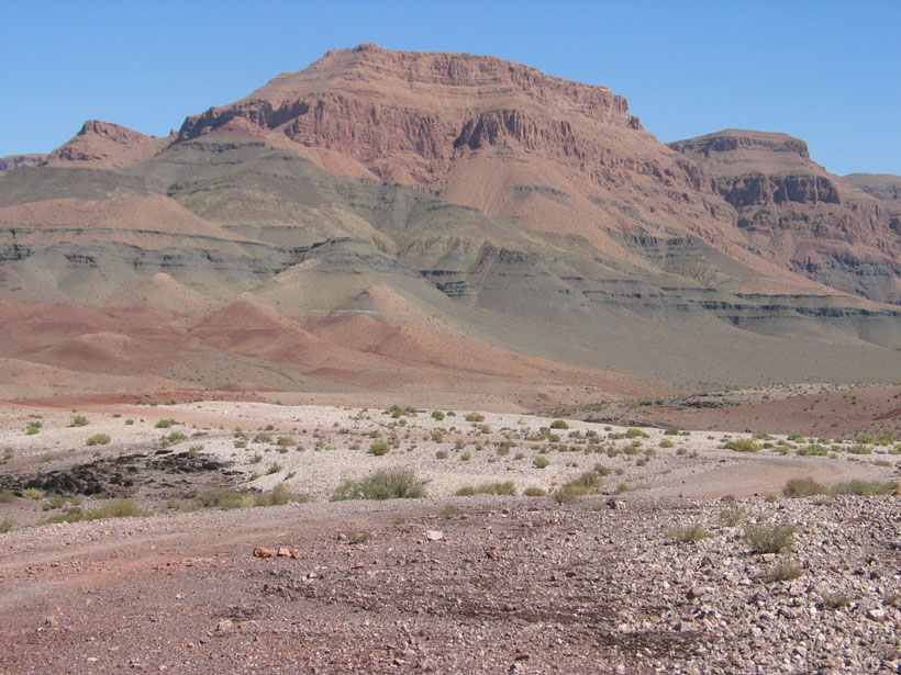 Image of red and gray layers of rock in a mountain in Morocco