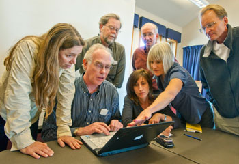 NGEE Arctic team members look at a laptop to study a map of the road system and surrounding vegetation and land features near Nome, Alaska. NGEE Arctic team members look at a laptop to study a map of the road system and surrounding vegetation and land features near Nome, Alaska.