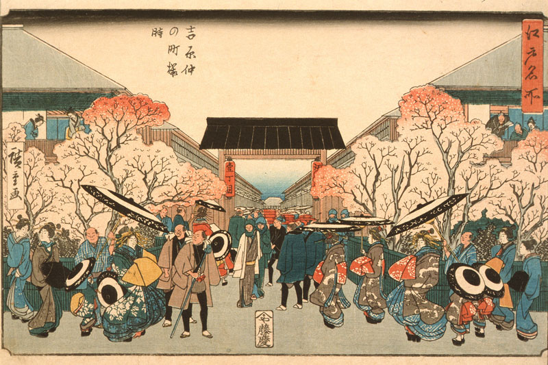 Woodblock print of a busy 19th-century Japanese street flanked by cherry blossoms