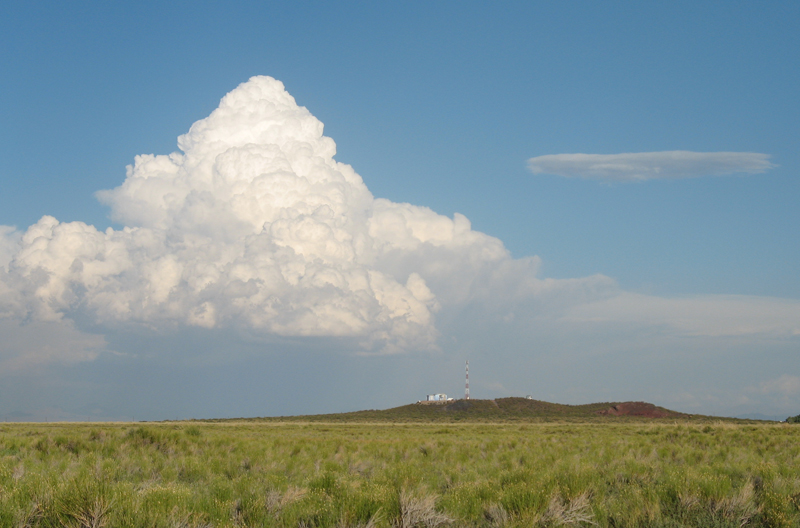 A thunderstorm looms on the horizon near the hillside site of one of the Pierre Auger Observatory’s fluorescence detectors