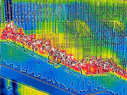 A thermal infrared photo of several dozen people standing on a staircase