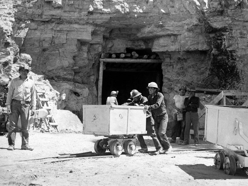 Black-and-white image of Navajo mine workers at a uranium mine
