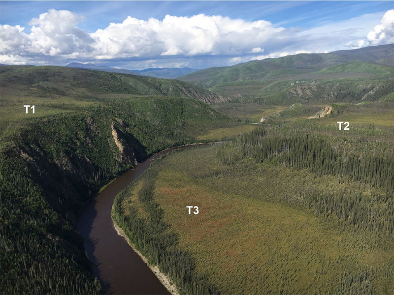Aerial view of a bend in the Fortymile River and the surrounding landscape in Alaska