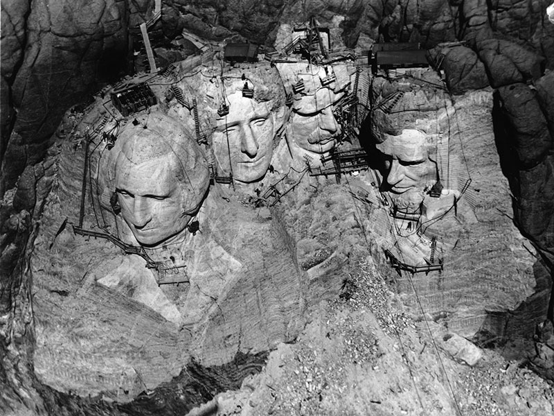 An aerial view of the nearly completed carving on Mount Rushmore shows the scaffolding and ropes used to access the steep face of the mountain. An aerial view of the nearly completed carving on Mount Rushmore shows the scaffolding and ropes used to access the steep face of the mountain.