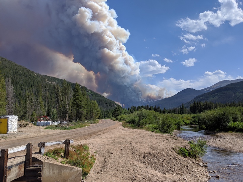 Smoke billows from a wildfire in the Rocky Mountains